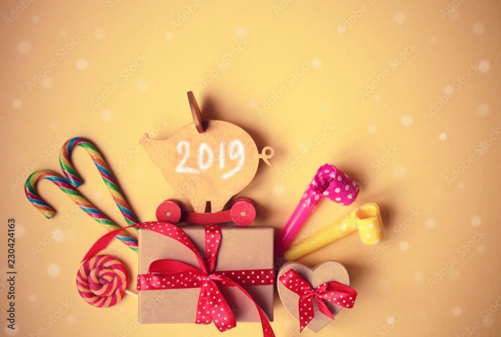 New Year card with figure of wooden pig, gifts,candies, candles/2010 year of a yellow pig/ chinese New Year New Year card with figure of wooden pig, gifts,candies, candles/2010 year of a yellow pig/ chinese New Year