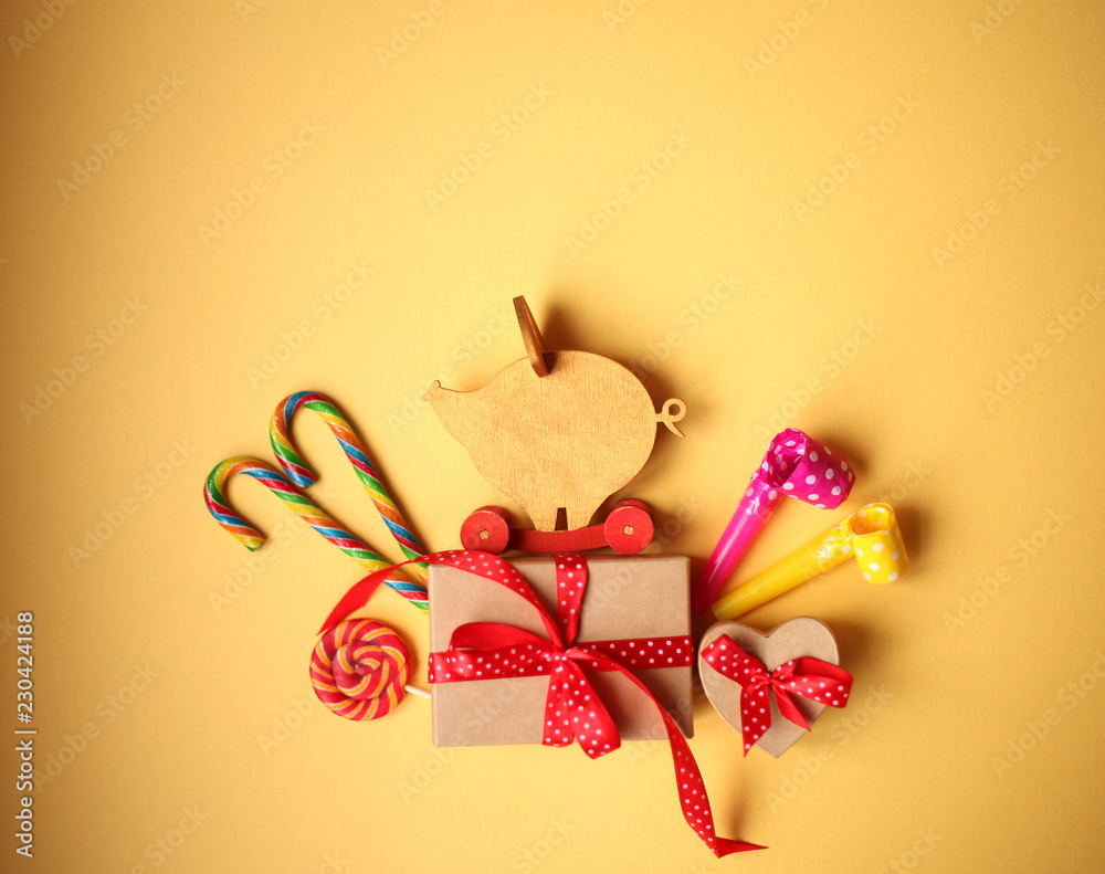 New Year card with figure of wooden pig, gifts,candies, candles/2010 year of a yellow pig/ chinese New Year New Year card with figure of wooden pig, gifts,candies, candles/2010 year of a yellow pig/ chinese New Year