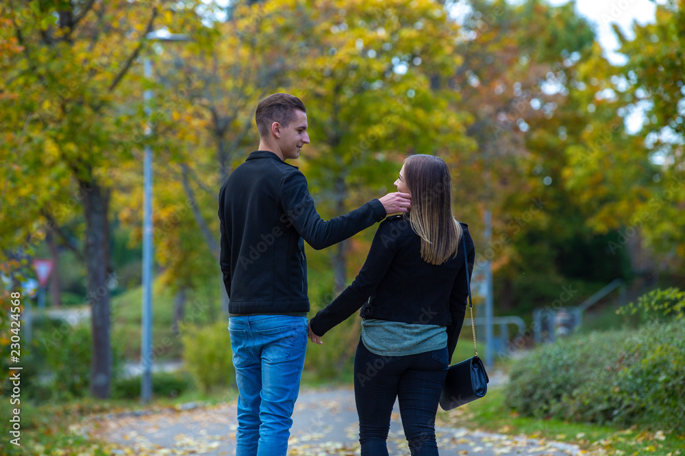 Young couple in love walking in the autumn park