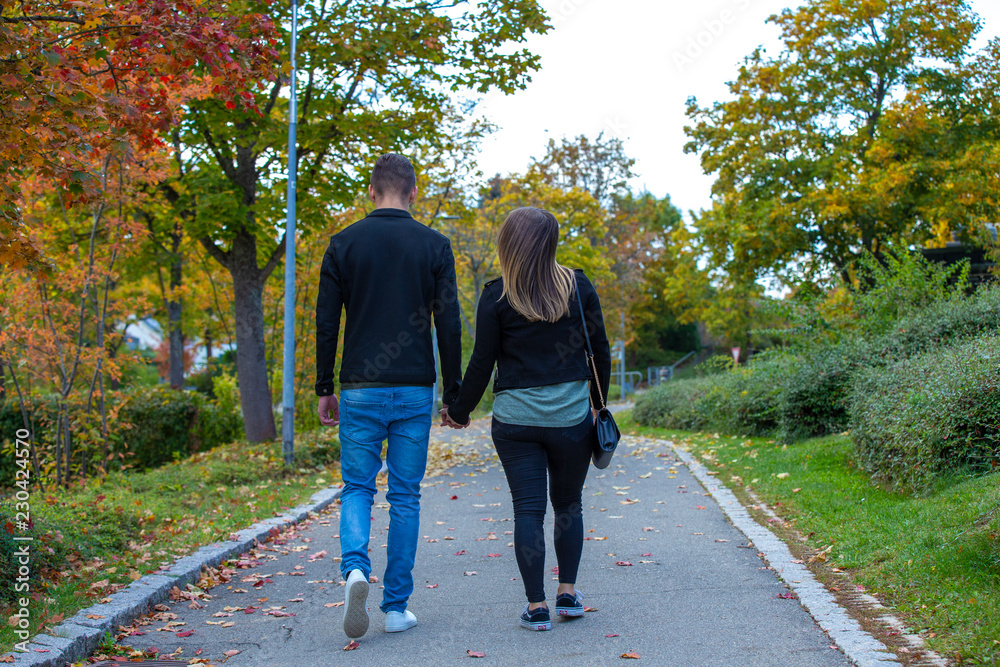 Young couple in love walking in the autumn park