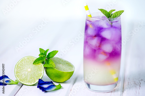 Butterfly pea flower drink with lime , honey and mint leaf , a fresh herbal healthy detox drink photo