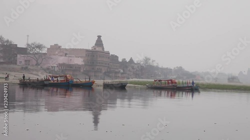 Still shot of boats on the banks of a river