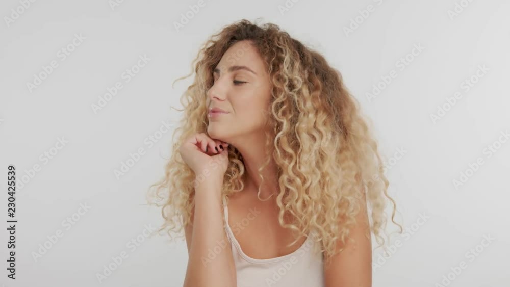 model with blonde curly hair and natural meakup poses in studio model with blonde curly hair and natural meakup poses in studio