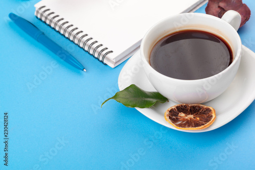 Flat lay photo with notebook   coffee cup on blue Background