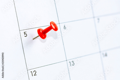 5 date on calendar with Red color pin. fifth day of month is marked with red thumbtack. Save the date. photo