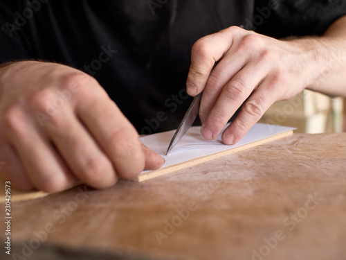 The process of making a cutaway on a classical guitar..