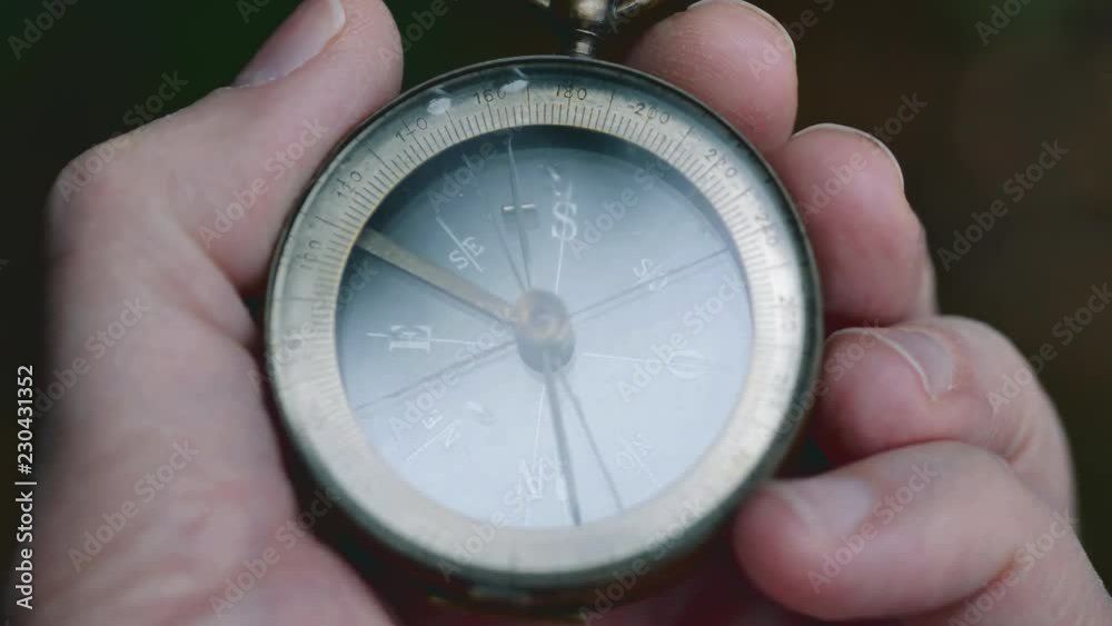 Close up on old compass instrument in hand. shot in slow motion Close up on old compass instrument in hand. shot in slow motion