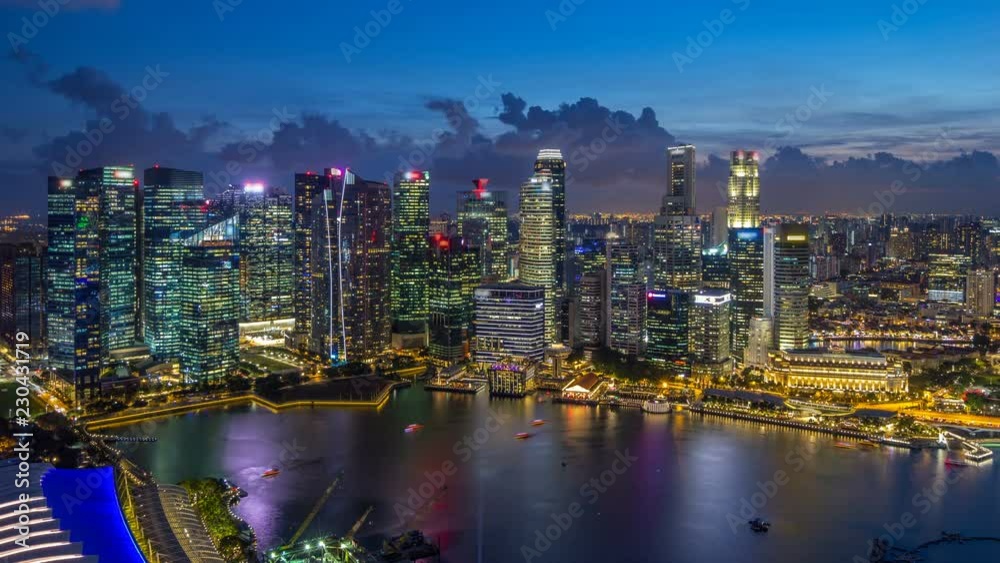 A view of Singapore business district skyscrapers at evening with water reflections day to night timelapse A view of Singapore business district skyscrapers at evening with water reflections day to night timelapse