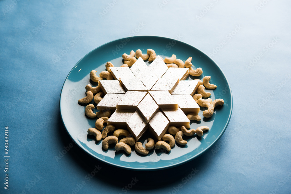 Kaju Katli is a Diamond shape Indian sweet made using cashew sugar and mava, served in a plate or bowl over moody background. selective focus Kaju Katli is a Diamond shape Indian sweet made using cashew sugar and mava, served in a plate or bowl over moody background. selective focus