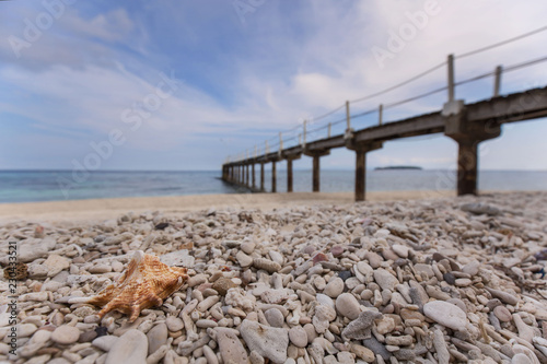 Coral stone beach with pier runway to sumilon island with a luxury resort a paradise photo