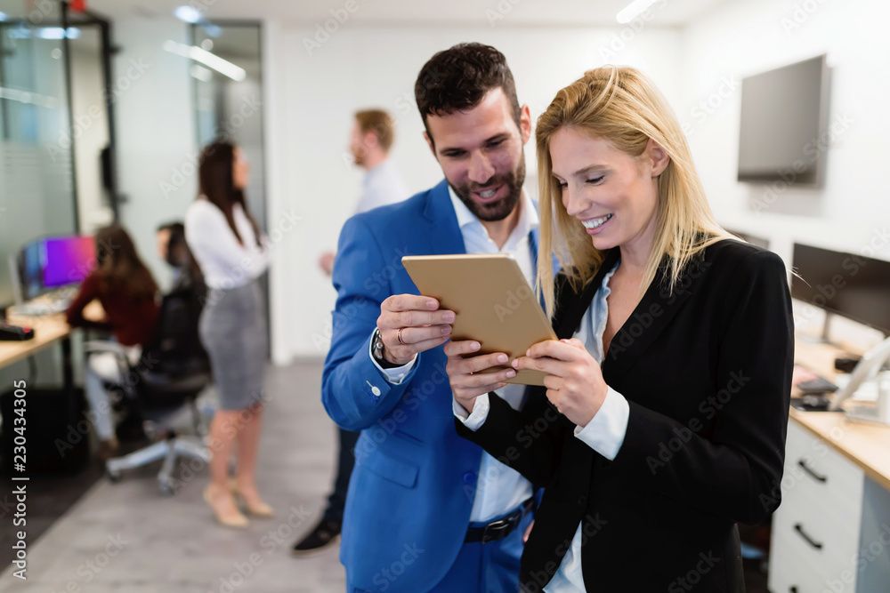 Attractive business couple using tablet in their company Attractive business couple using tablet in their company