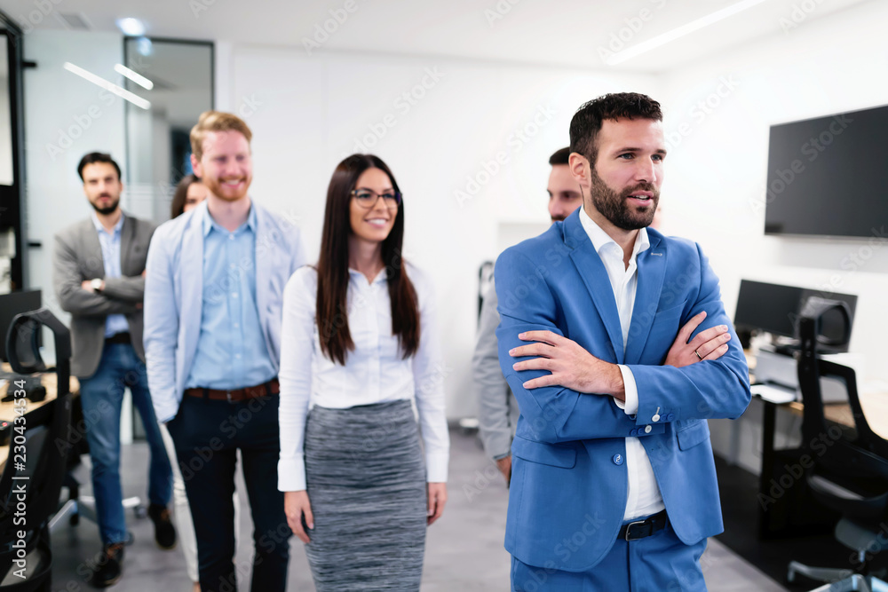 Successful team of young perspective businesspeople in office Successful team of young perspective businesspeople in office
