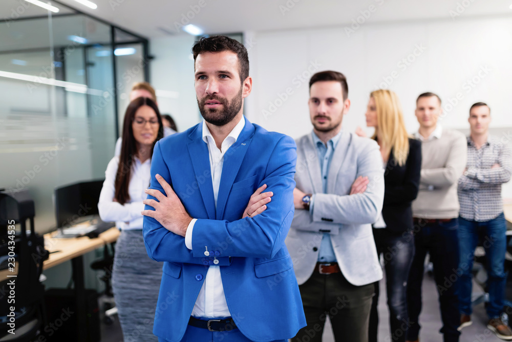 Successful team of young perspective businesspeople in office Successful team of young perspective businesspeople in office