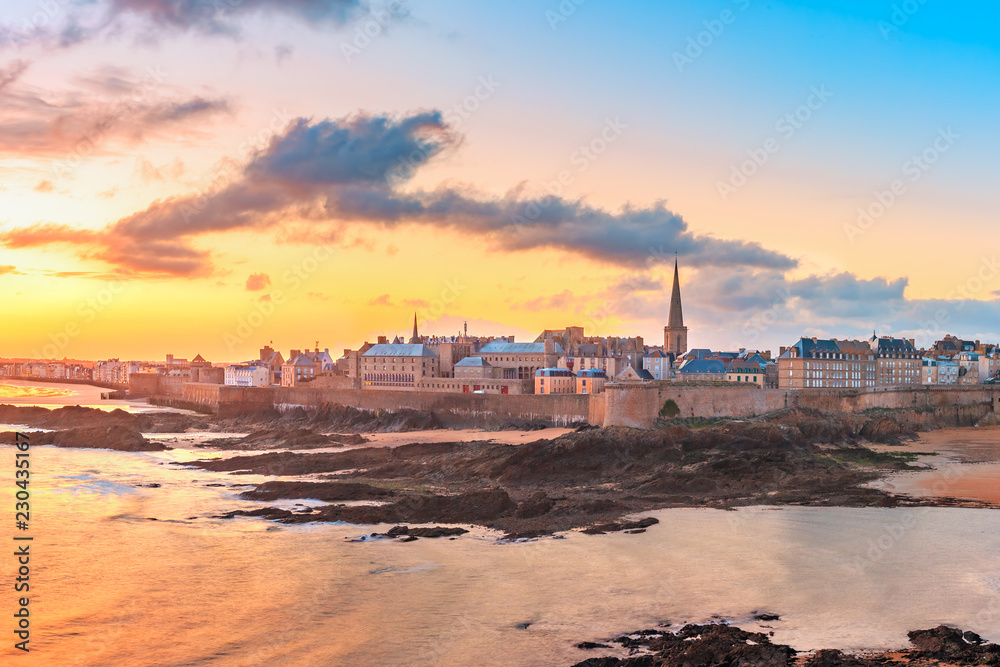 Walled city Saint-Malo with St Vincent Cathedral at sunrise at high tide. Saint-Maol is famous port city of Privateers is known as city corsaire, Brittany, France