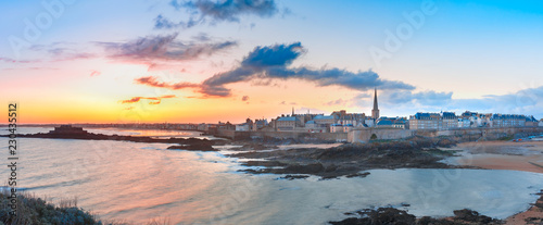 Panoramic view of walled city Saint-Malo with St Vincent Cathedral at sunrise at high tide. Saint-Maol is famous port city of Privateers is known as city corsaire, Brittany, France