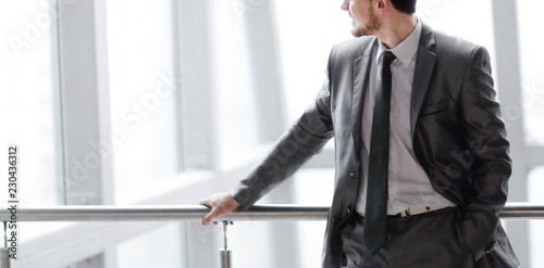 successful businessman standing in the lobby of a modern office