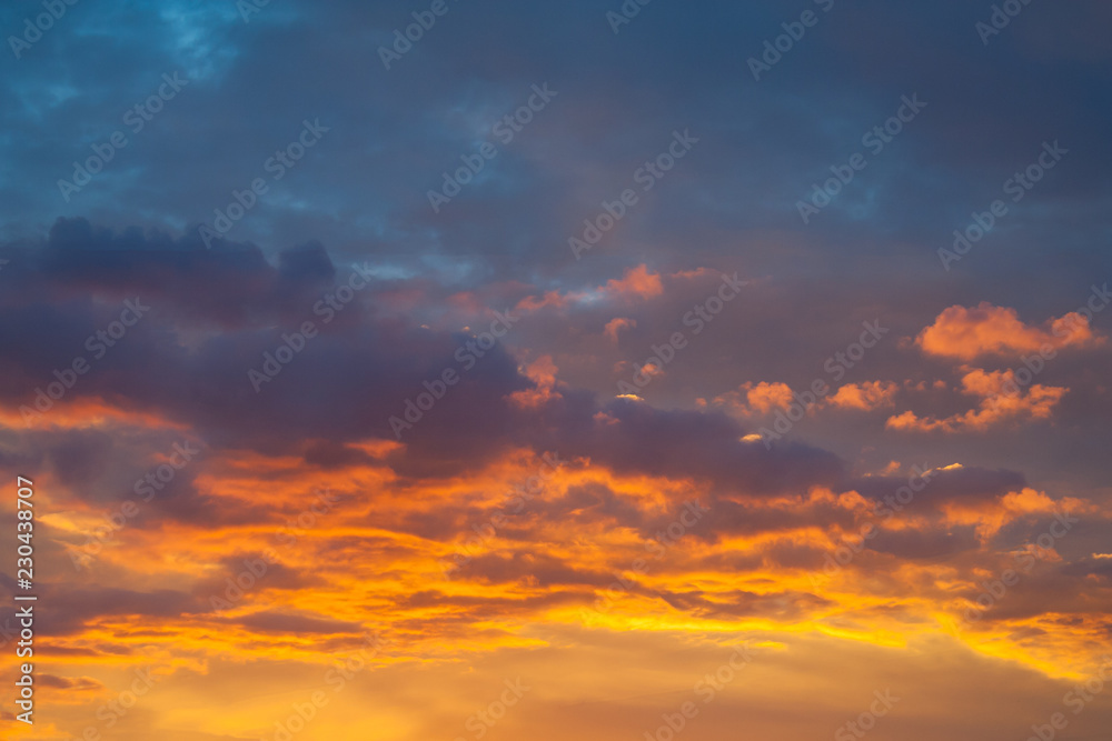 Dramatic view on a orange clouds in evening sky