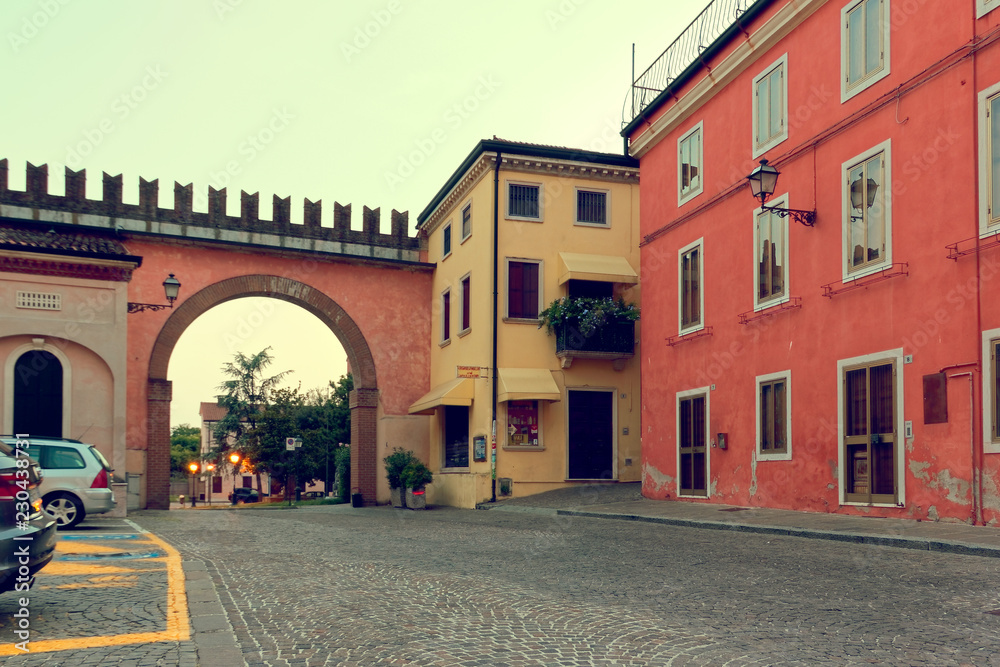 Fototapeta premium Verona, Italy-August 5, 2018: Village of Colonia Veneto. Beautiful street with retro houses in the evening.
