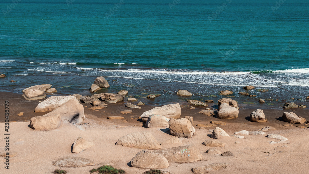 Rocky sea coast with turquoise water on the beach