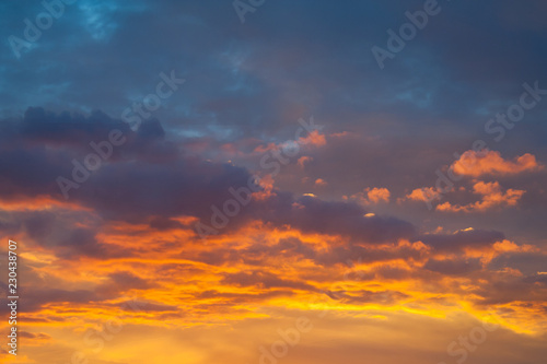 Dramatic view on a orange clouds in evening sky