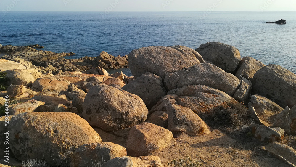 dav foto stock royalty free: 1217268076 Sardinia, Italy, a stretch of wild and rocky southwestern coast at sunset