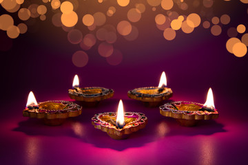 Happy Diwali - Clay Diya lamps lit during Dipavali, Hindu festival of lights celebration