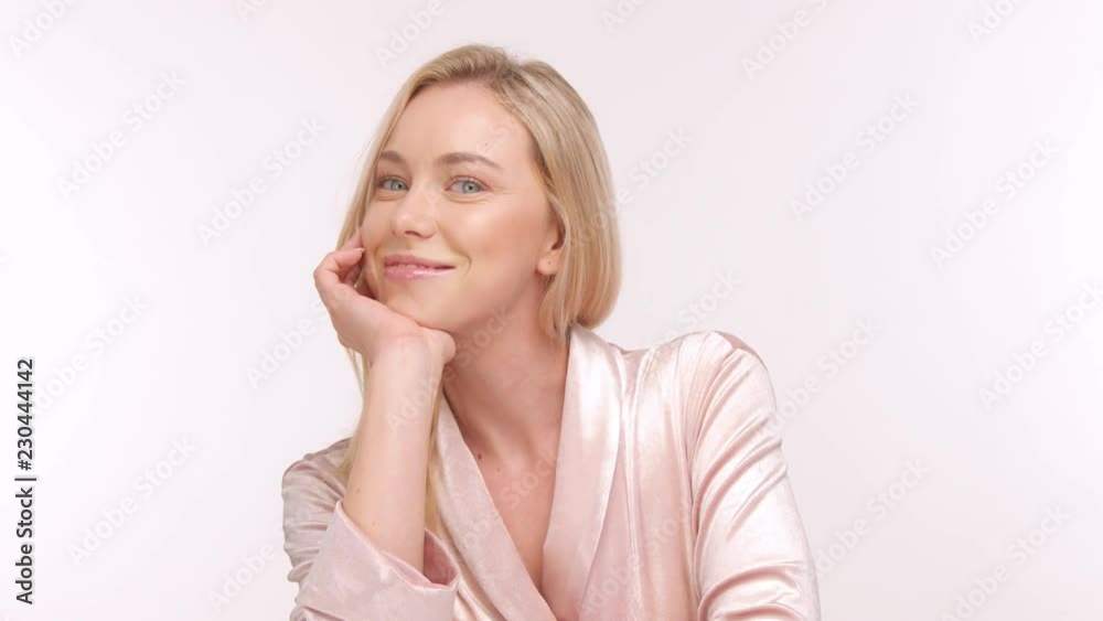 beauty nordic model in studio poses to camera. Wears a bathrobe beauty nordic model in studio poses to camera. Wears a bathrobe