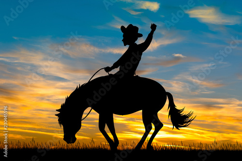 man on a rodeo horse at sunset