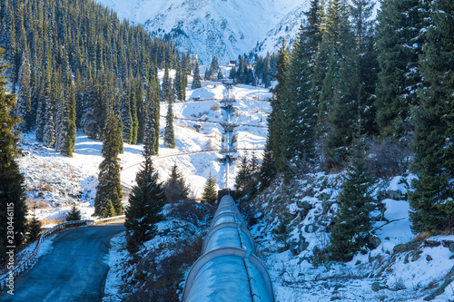 oil pipeline in winter in the mountains photo