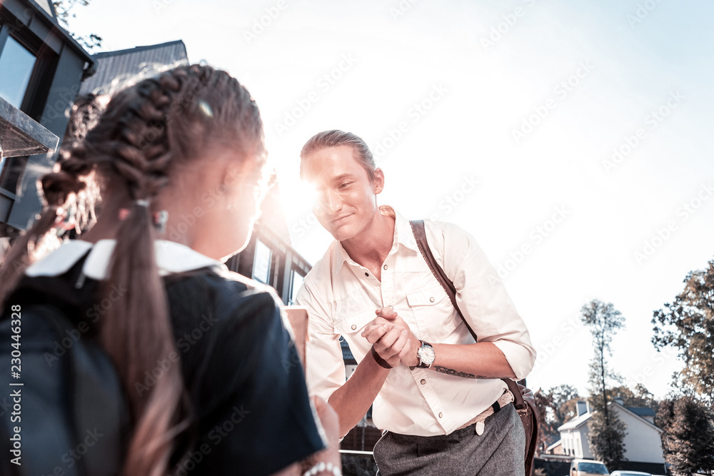 Modern father. Stylish modern loving and caring father with tattoo on hand taking his little girl to school Modern father. Stylish modern loving and caring father with tattoo on hand taking his little girl to school