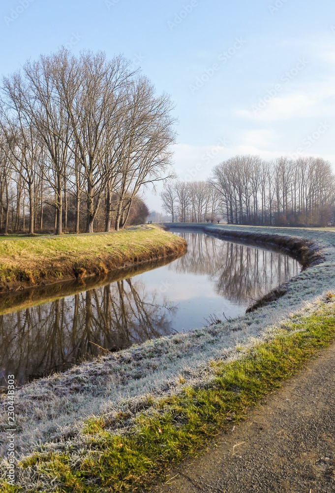 Winter landscape of the river Dyle flowing through the in frost covered countryside from Muizen to Bonheiden, Belgium Winter landscape of the river Dyle flowing through the in frost covered countryside from Muizen to Bonheiden, Belgium
