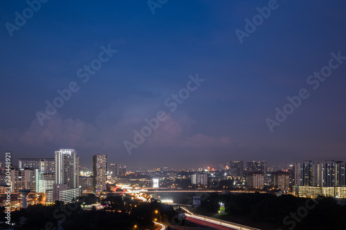 Urban city during blue hour with dramatic sky