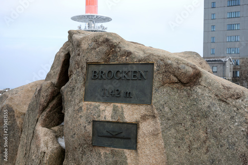 Gipfelstein mit Tafel auf dem Brocken im Harz photo