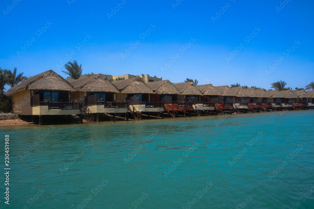 Beautiful view of the coastline with houses and hotels on the red sea. Tourist region in Egypt. Hurghada and its traditions. Stock photo for design Beautiful view of the coastline with houses and hotels on the red sea. Tourist region in Egypt. Hurghada and its traditions. Stock photo for design