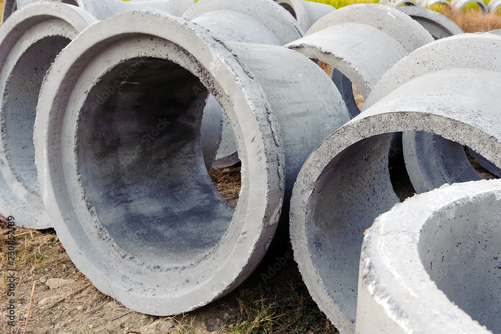 New concrete pipes (rings) are on the ground. Shot close up New concrete pipes (rings) are on the ground. Shot close up