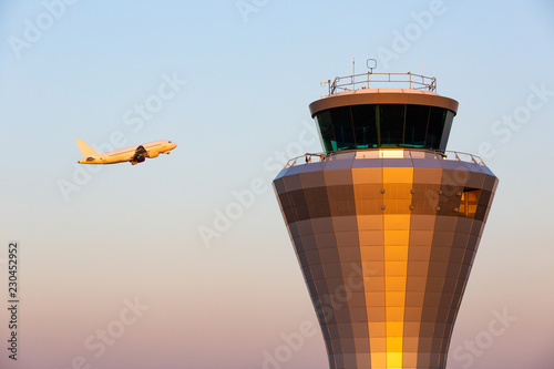 фотографія Jet Plane Pasing Air Traffic Control Tower