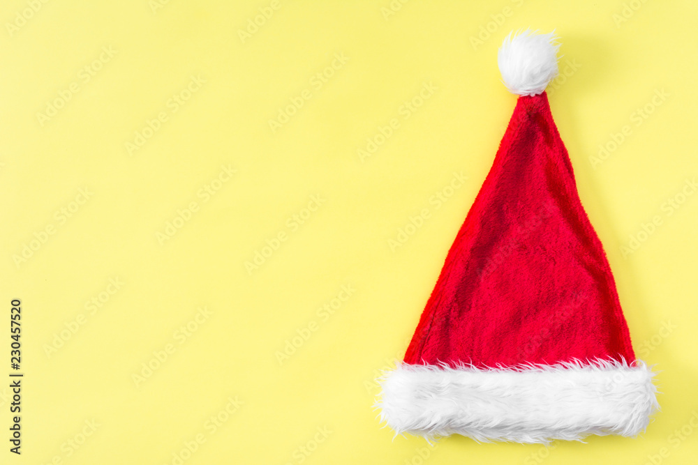 Santa claus hat. Christmas pastel yellow background. Santa claus hat. Christmas pastel yellow background.