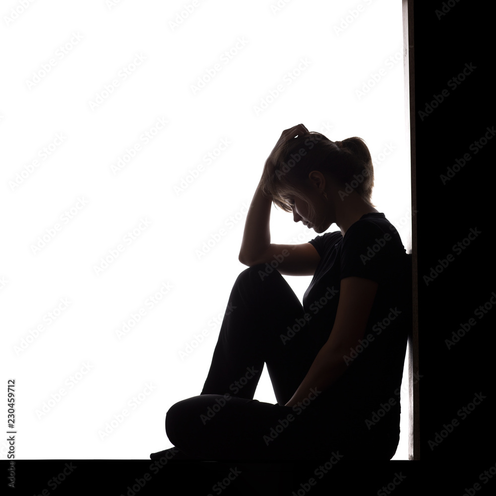 silhouette of a woman sitting on the floor in a corner on a white isolated  background, a sad girl thinking about problems Stock Photo | Adobe Stock