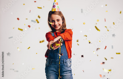 Girl bursting a party popper