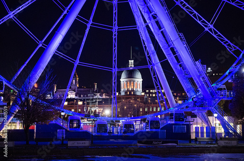 Bonsecours Market is shown behind a ferris wheel in the Old Port of Montreal