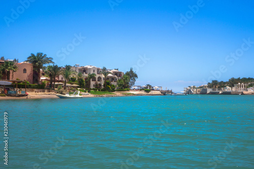 Fototapeta Naklejka Na Ścianę i Meble -  Beautiful view of the coastline with houses and hotels on the red sea. Tourist region in Egypt. Hurghada and its traditions. Stock photo for design