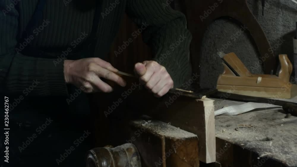 carpenter uses a carpenter's chisel