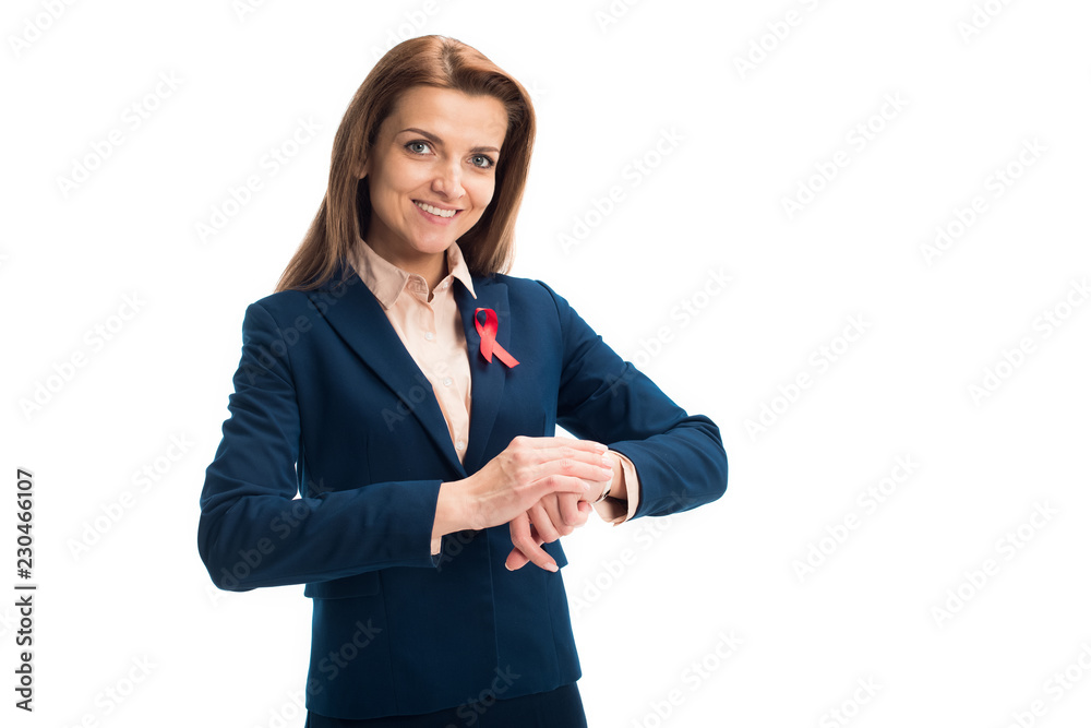 smiling attractive businesswoman with red ribbon on suit checking time isolated on white, world aids day concept smiling attractive businesswoman with red ribbon on suit checking time isolated on white, world aids day concept