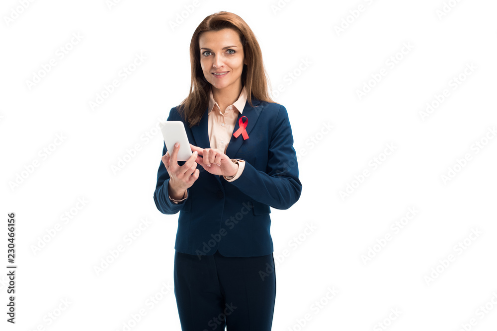 attractive businesswoman with red ribbon on suit using smartphone isolated on white, world aids day concept attractive businesswoman with red ribbon on suit using smartphone isolated on white, world aids day concept