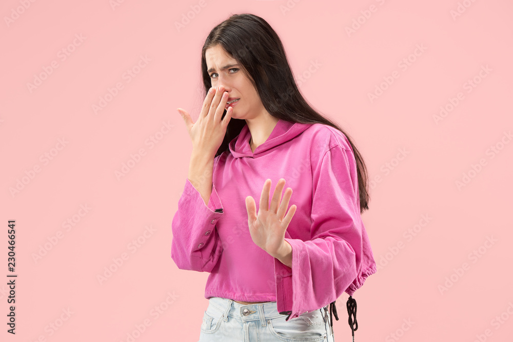 Reject, rejection, doubt concept. Doubtful woman with thoughtful expression making choice. Young emotional woman. Human emotions, facial expression concept. Studio. Isolated on trendy pink Reject, rejection, doubt concept. Doubtful woman with thoughtful expression making choice. Young emotional woman. Human emotions, facial expression concept. Studio. Isolated on trendy pink