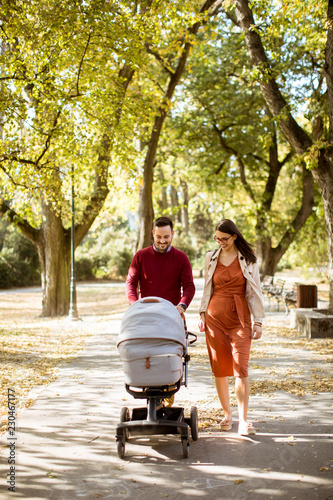 Happy young parents walking...