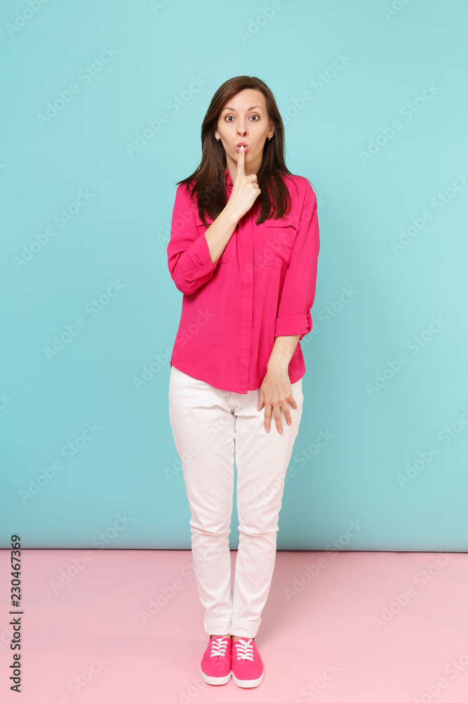Full length portrait of smiling young pretty woman in rose shirt blouse, white pants posing isolated on bright pink blue pastel wall background studio. Fashion lifestyle concept. Mock up copy space. Full length portrait of smiling young pretty woman in rose shirt blouse, white pants posing isolated on bright pink blue pastel wall background studio. Fashion lifestyle concept. Mock up copy space.