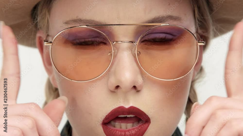 closeup of woman in cowboy style closeup woman´s eyes behind yellow glasses