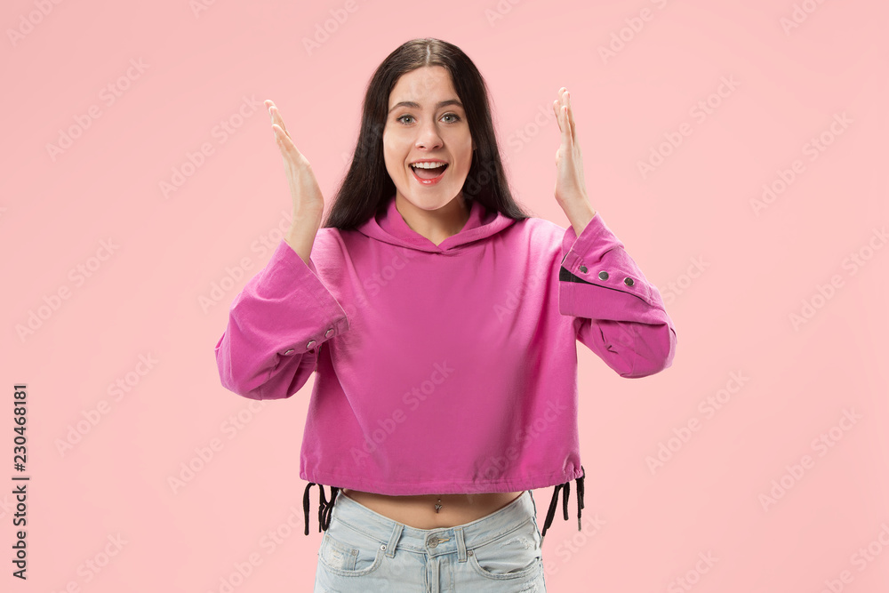 Wow. Beautiful female half-length front portrait isolated on pink studio backgroud. Young emotional surprised woman standing with open mouth. Human emotions, facial expression concept. Trendy colors Wow. Beautiful female half-length front portrait isolated on pink studio backgroud. Young emotional surprised woman standing with open mouth. Human emotions, facial expression concept. Trendy colors