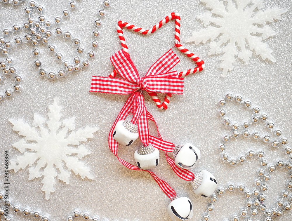 Fototapeta premium Shining Christmas background - red star with bells, snowflakes and silver necklace